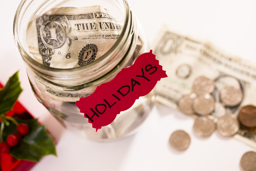 Money in a jar for the holiday season, having a holiday budget